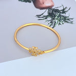 Openable gold bangle with diamond-set cross charm clasp