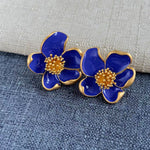 Deep blue enamel floral stud earrings with gold-tone petals and beaded center