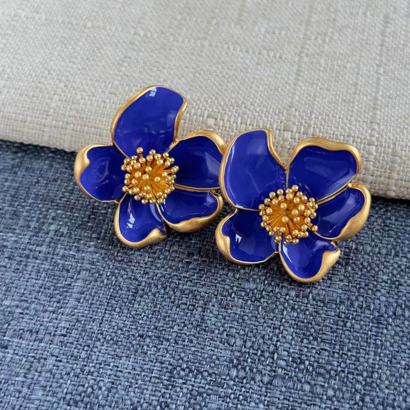 Deep blue enamel floral stud earrings with gold-tone petals and beaded center