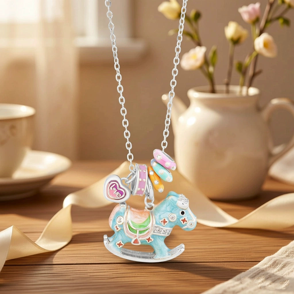 Enamel rocking horse necklace with silver chain, blue horse charm and purple heart teacup