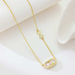 Pink rose-print oval pendant with bow charm on gold chain