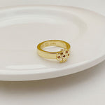 Gold-tone openwork ring with raised crest and engraved inner markings
