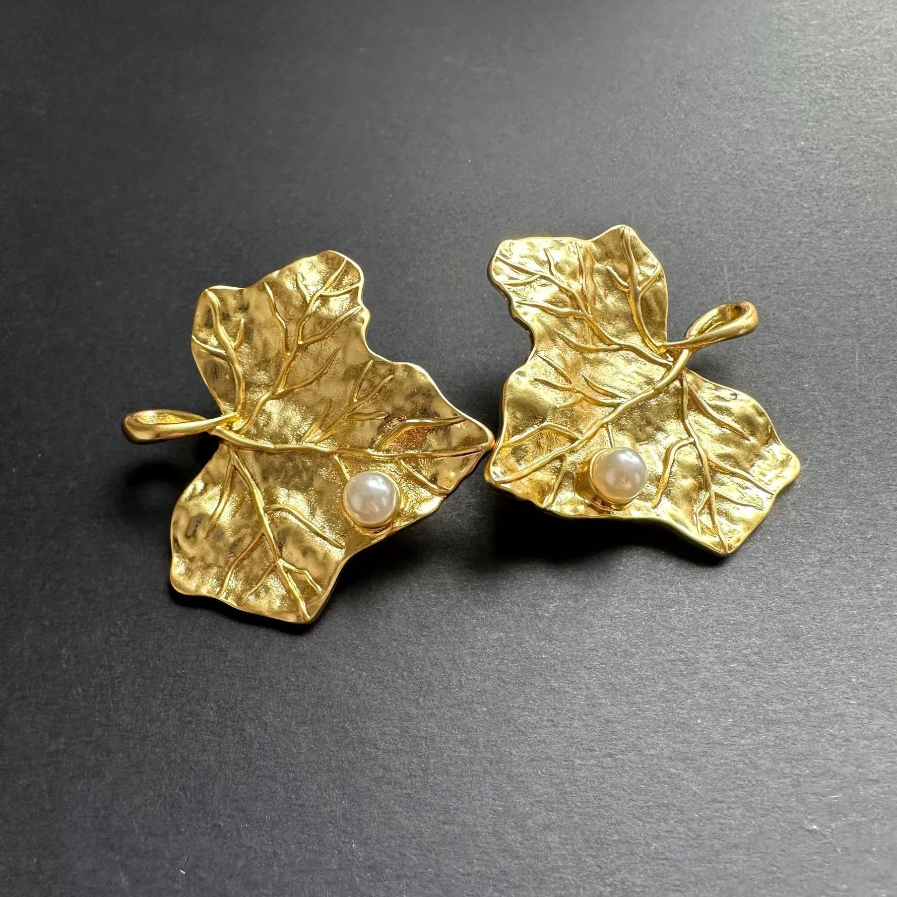 Gold-tone ivy leaf pearl earrings with textured leaf detailing and white pearls