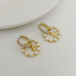 Gold-tone hoop pendant earrings with rhinestones and white pearl drops