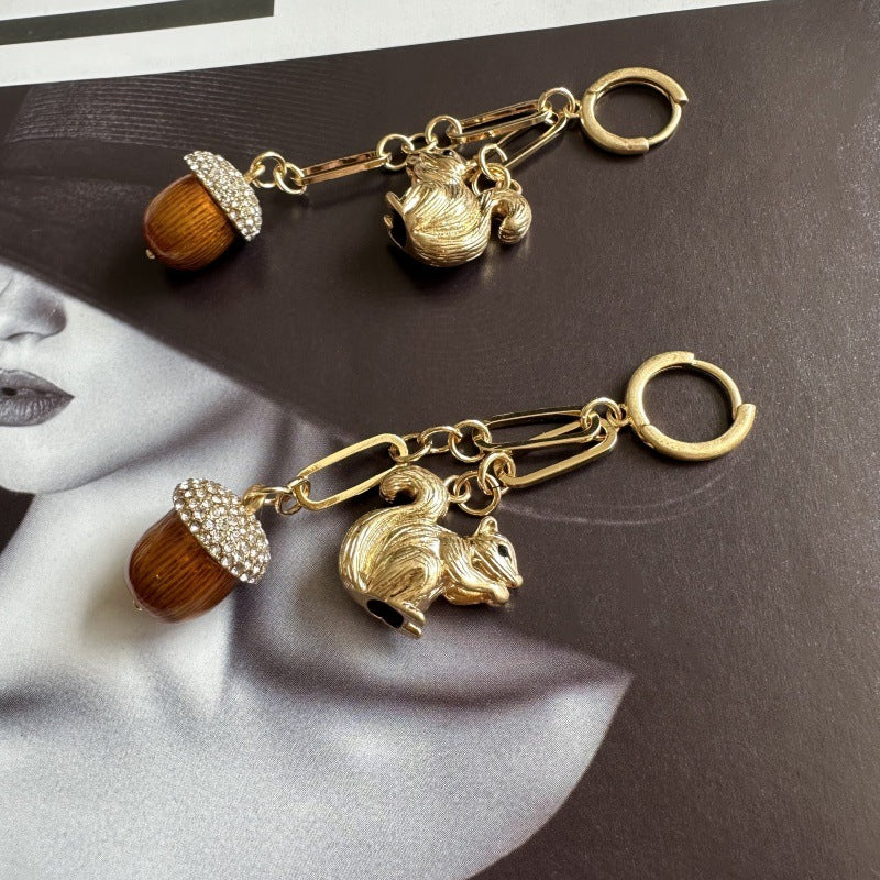 Gold squirrel and pinecone drop earrings with jeweled acorn-like tassels and dangle hoops