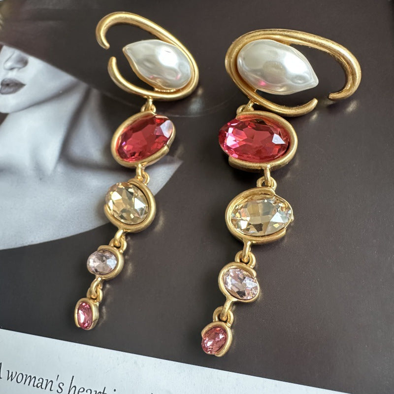 Long crystal drop earrings in gold with red, clear, and pink accents