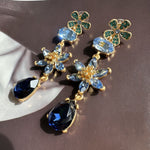 Blue crystal floral drop earrings with green clover studs and pear teardrop dangles