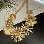 Gold-tone daisy flower necklace with large layered flower pendants and lobster clasp