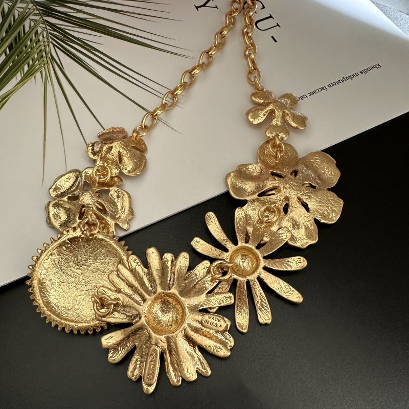 Gold-tone daisy flower necklace with large layered flower pendants and lobster clasp