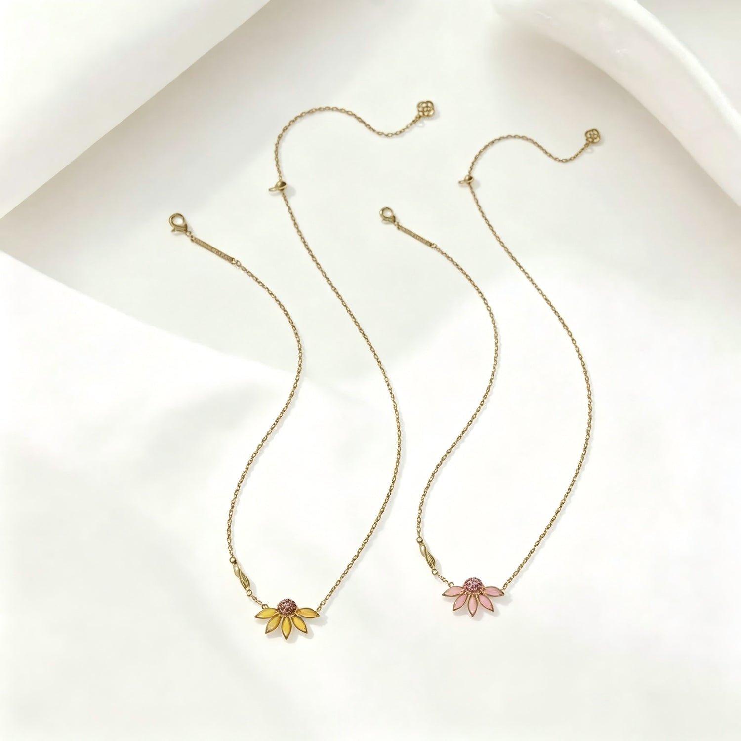 Gold-tone flower pendant necklace set with daisy charms and rhinestone centers