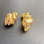 Conch earrings, gold tone, close-up with pink and clear diamond-like stones