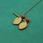 Wooden heart-shaped earrings with leopard-pattern faces and brown spherical tops