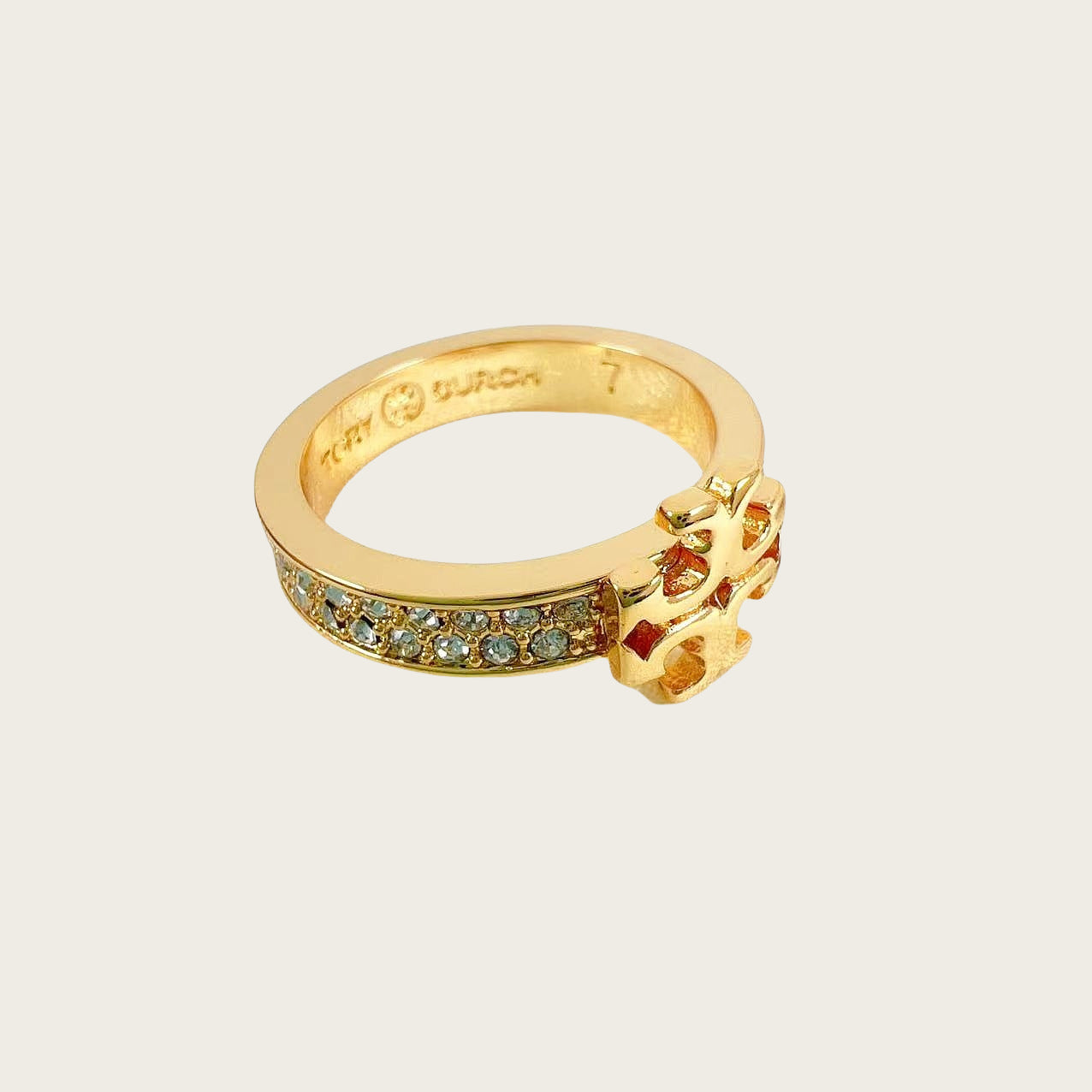 Gold diamond logo ring with blue pavé band and raised logo center