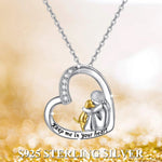 Heart pendant necklace with rhinestone trim, mother-and-child figures and 'Keep me in your heart'