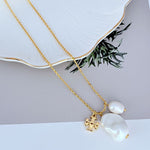 Gold-tone pendant necklace with two white baroque pearls and logo charm