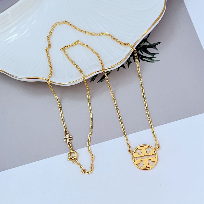 Gold minimalist openwork logo pendant necklace with round emblem and layered chain