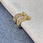 Gold-tone cubic zirconia C-hoop earrings with clear stones and textured stud backs