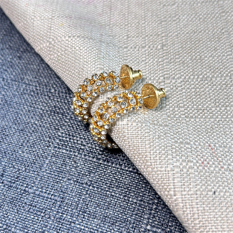 Gold-tone cubic zirconia C-hoop earrings with clear stones and textured stud backs