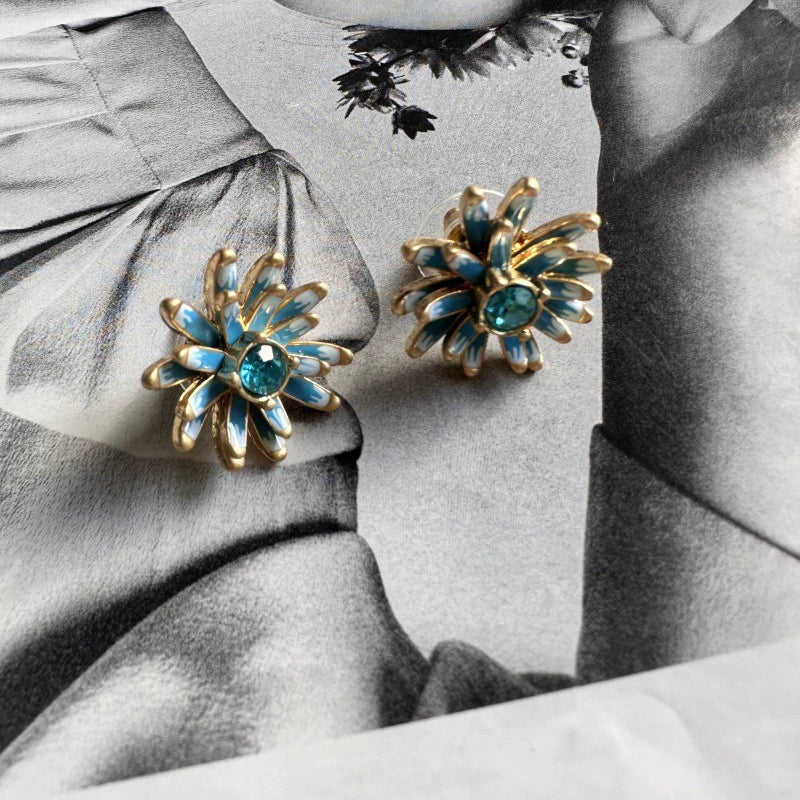 Enamel flower earrings with gold-tone petals and blue center stones, dangle drop studs