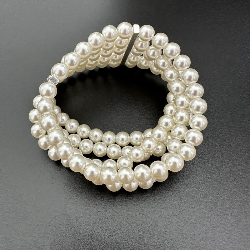 Multi-row pearl stretch bracelet with rhinestone accent strip between rows