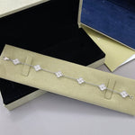 Silver-tone clover bracelet with white agate flower links and four-leaf pattern