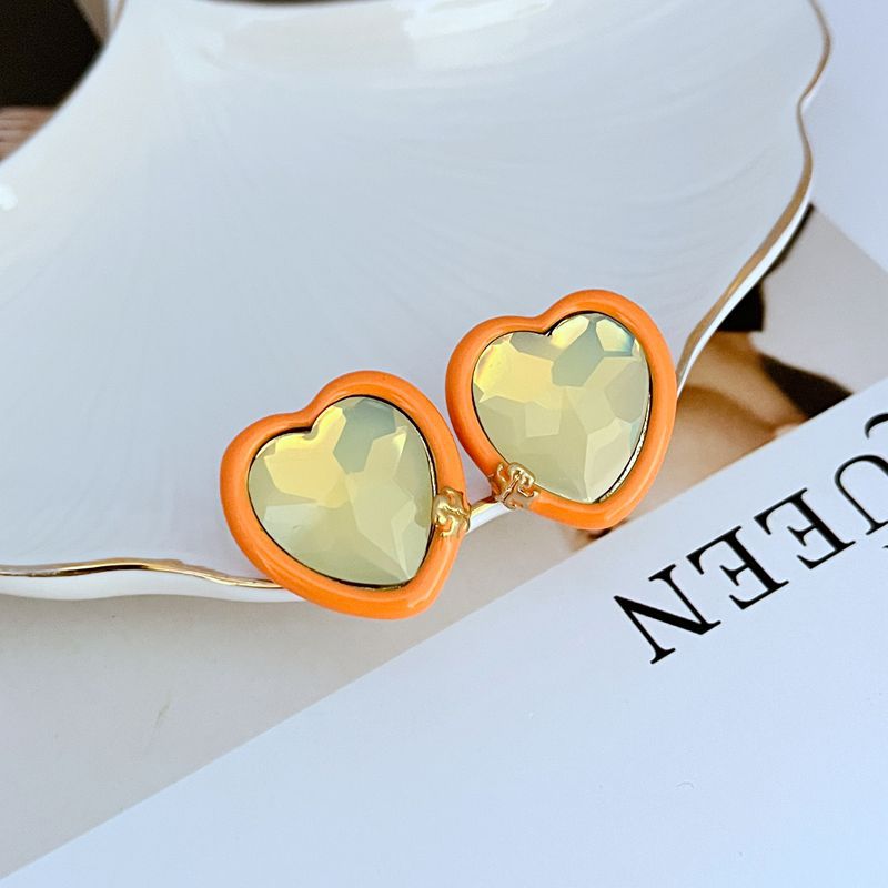 Yellow heart stud earrings with orange acrylic border and gold-tone posts