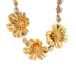 Gold-tone cherry blossom pendant necklace with sparkling clear rhinestone accents and chain links