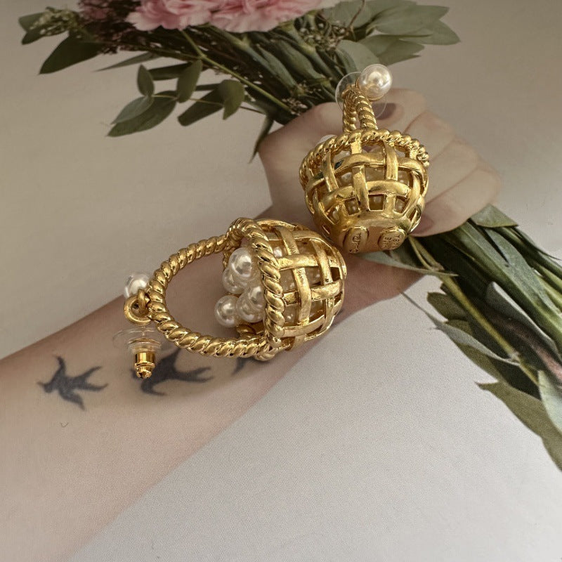 Gold basket-shaped earrings with pearl drops on woven rope and stud backs