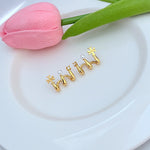 Gold M-shaped logo stud earrings with small pearl accents