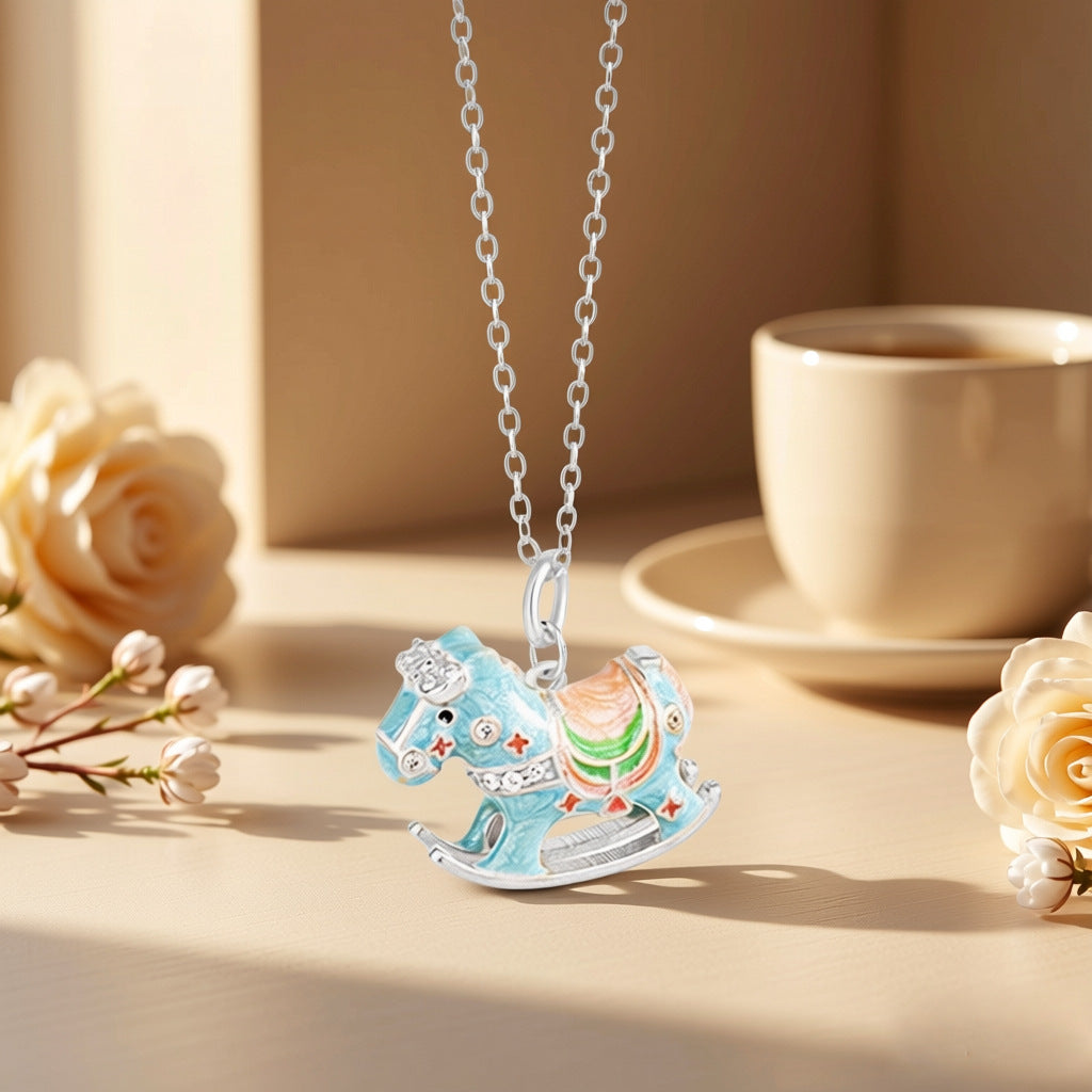 Enamel rocking horse necklace with silver chain and blue horse charm, enamel details