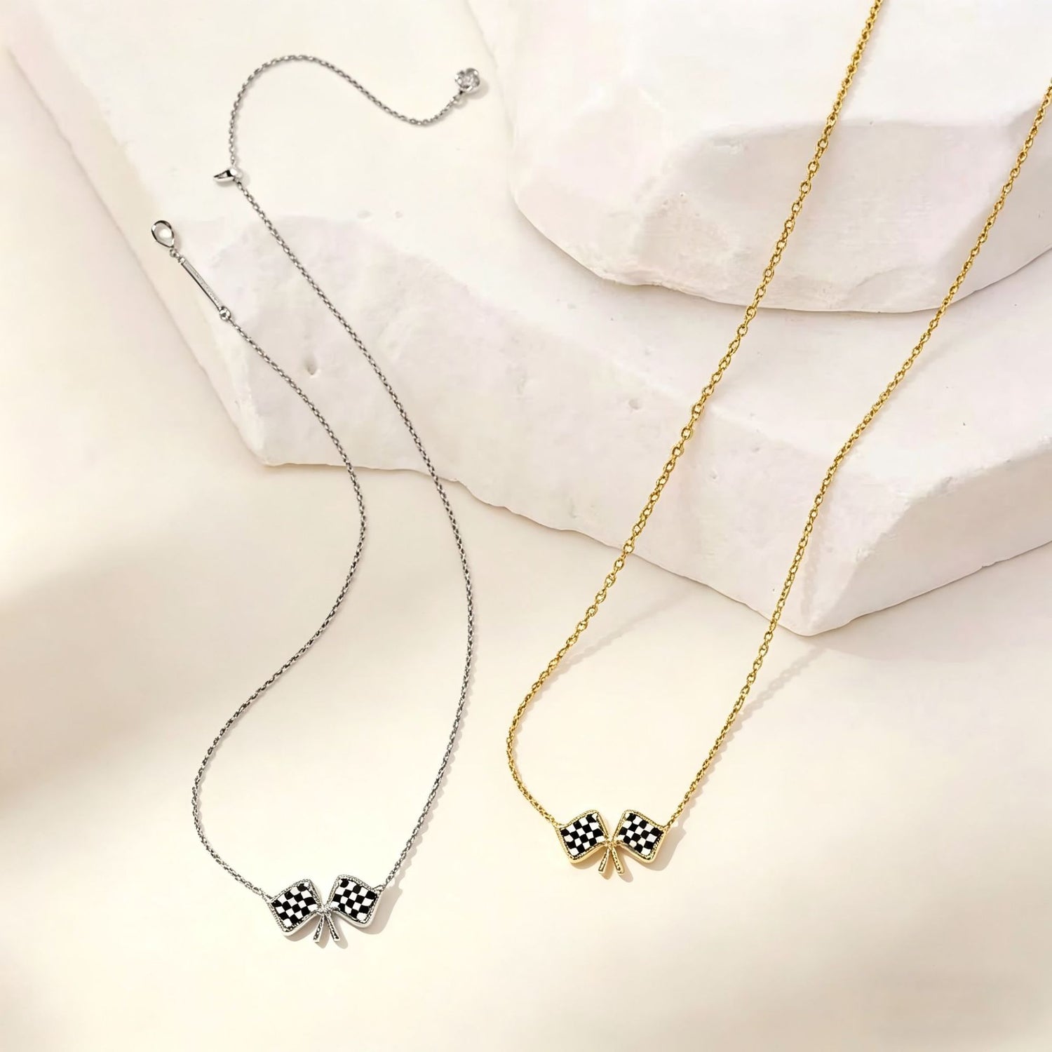 Silver and gold chain necklaces with checkered flag bow pendants