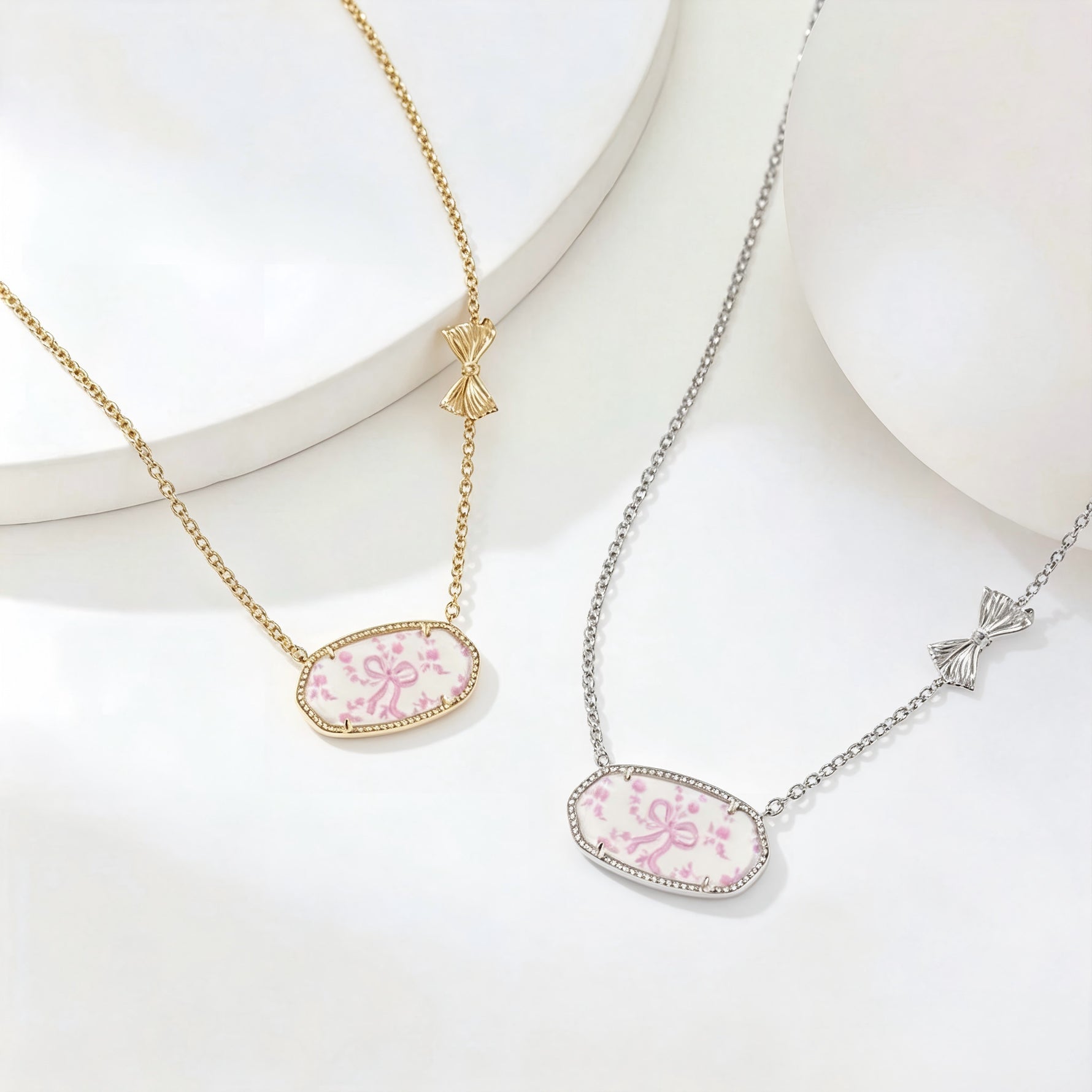 Gold- and silver-tone oval pendant bow necklaces with pink floral enamel