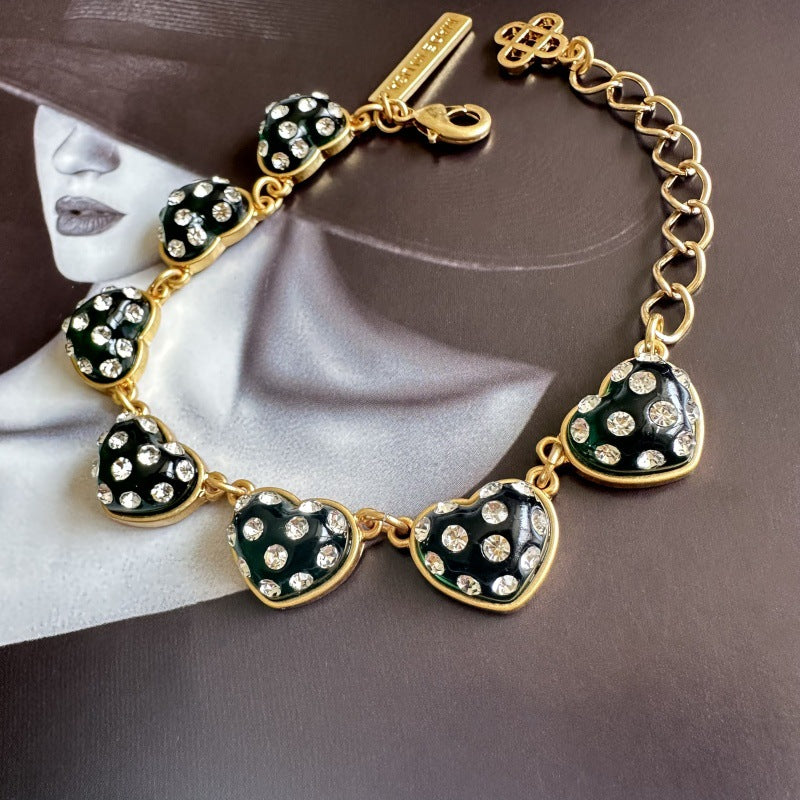 Green matte heart bracelet with rhinestone-look heart charms, gold-tone chain