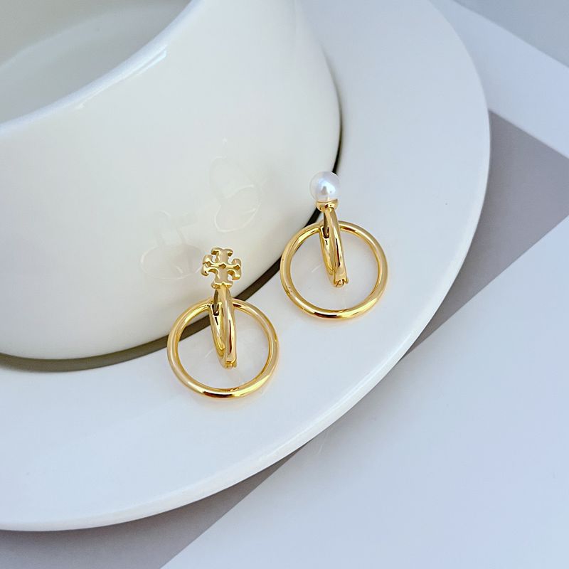 Gold-tone asymmetrical hoop earrings with pearl stud and small charm