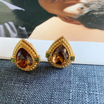 Brown crystal teardrop stud clip-on earrings with gold heart frame and green accents
