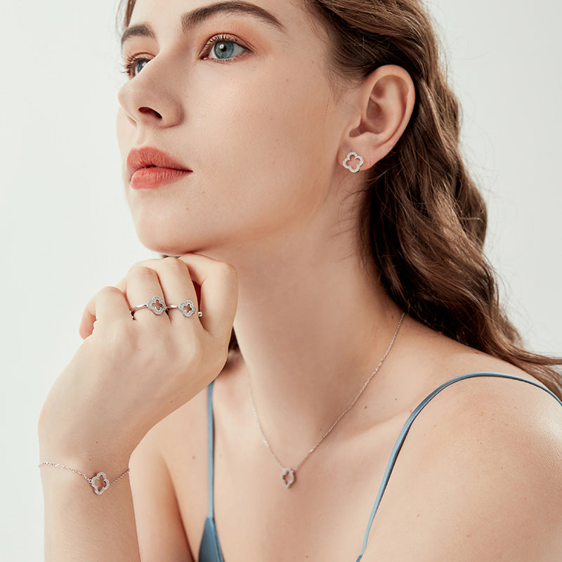 Four-leaf clover stud earrings in sterling silver on model's ear