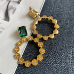 Emerald green zircon earrings with goldtone floral ring and small clear crystal accents