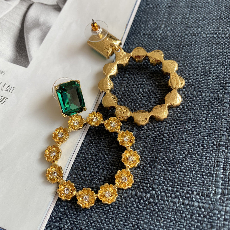 Emerald green zircon earrings with goldtone floral ring and small clear crystal accents
