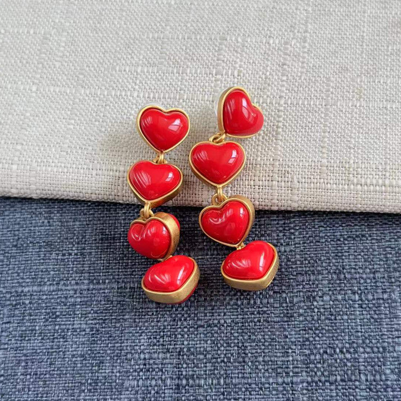 Smooth heart-shaped long drop earrings, glossy red heart drops with gold-tone links