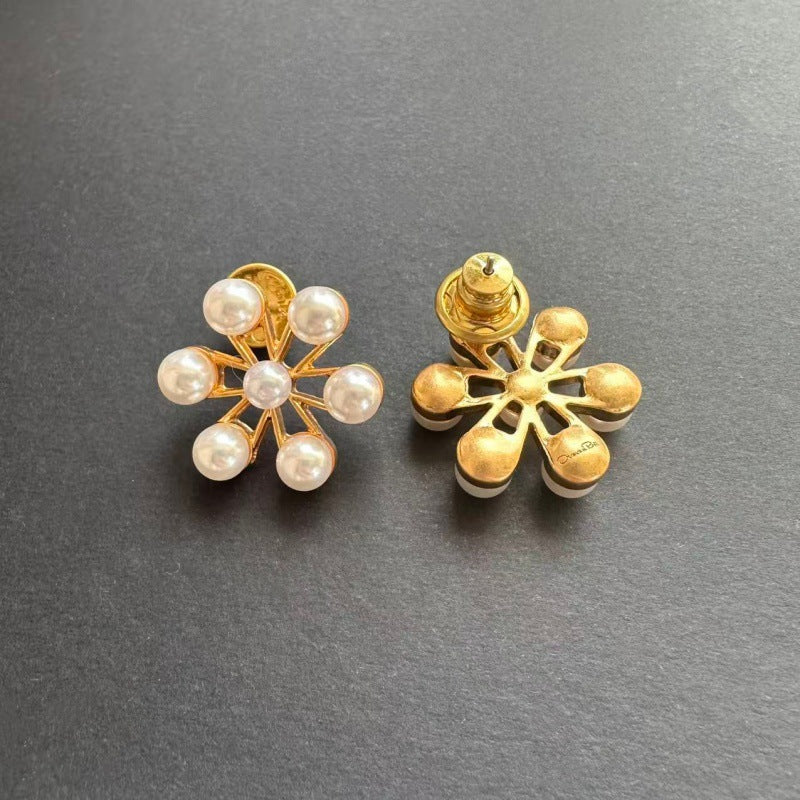 Gold-tone Ferris wheel pearl earrings with star design and ear back