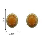 Earring size shown: 3 cm tall, 2.2 cm wide; oval yellow glass cabochon studs