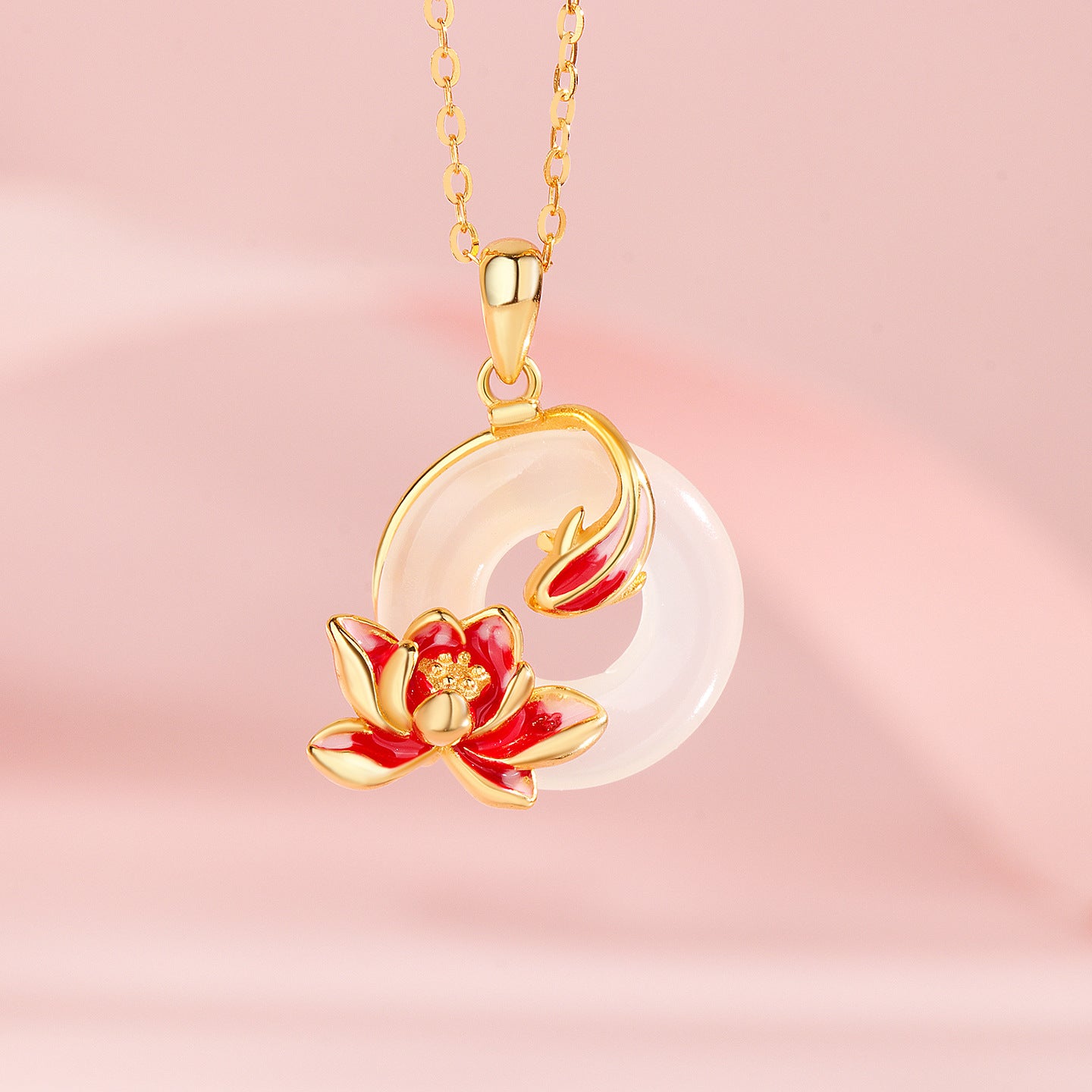 Gold-tone necklace with round white gemstone pendant and red enamel flower detail