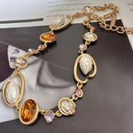 O-ring glass pearl necklace, orange-yellow, pink, and clear oval stones on gold chain