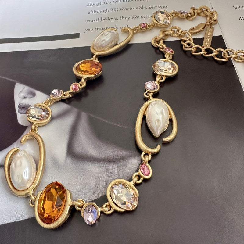 O-ring glass pearl necklace, orange-yellow, pink, and clear oval stones on gold chain