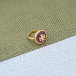 Round enamel metal ring with purple shell center and gold-tone band
