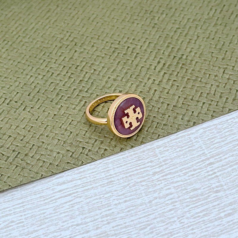Round enamel metal ring with purple shell center and gold-tone band