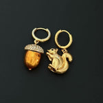 Gold-tone squirrel and acorn charm hoop earrings with crystal-studded cap