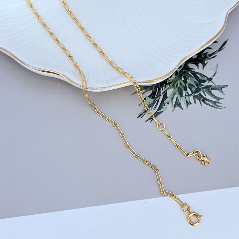 Gold-tone chain necklace with logo pendant and lobster clasp at the end