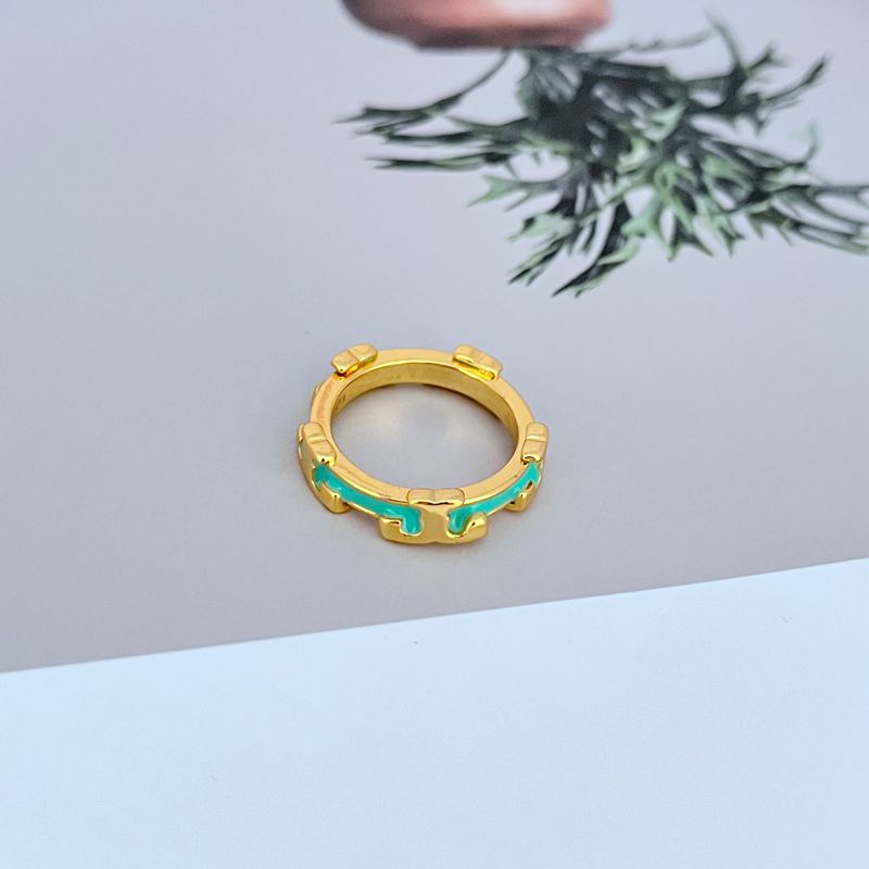 Gold-tone enamel geometric circle ring with teal/turquoise enamel accents