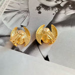 Emerald clip-on earrings, gold curved backs with oval bezel and crystal setting.